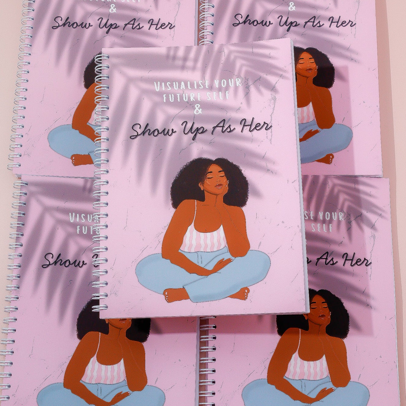 Set of notebooks with illustrated woman on pink background